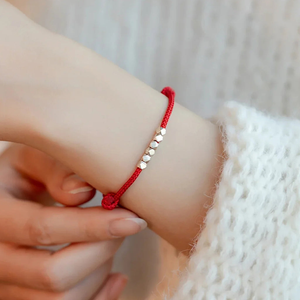 Red cord bracelet with large "broken silver" beads