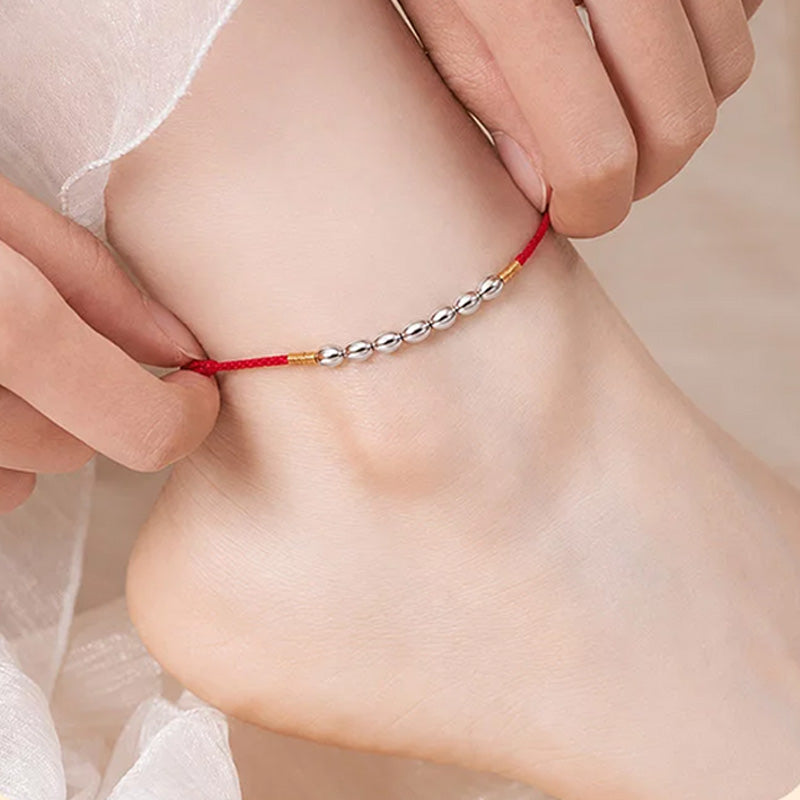 Red string with seven grains of rice