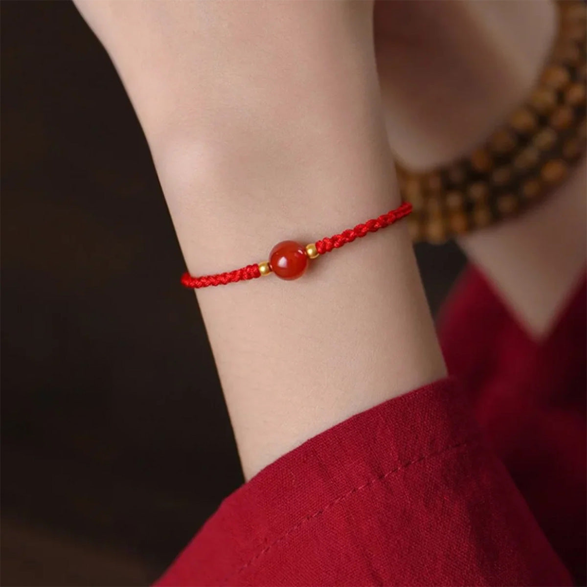 Red string bracelet with love beans
