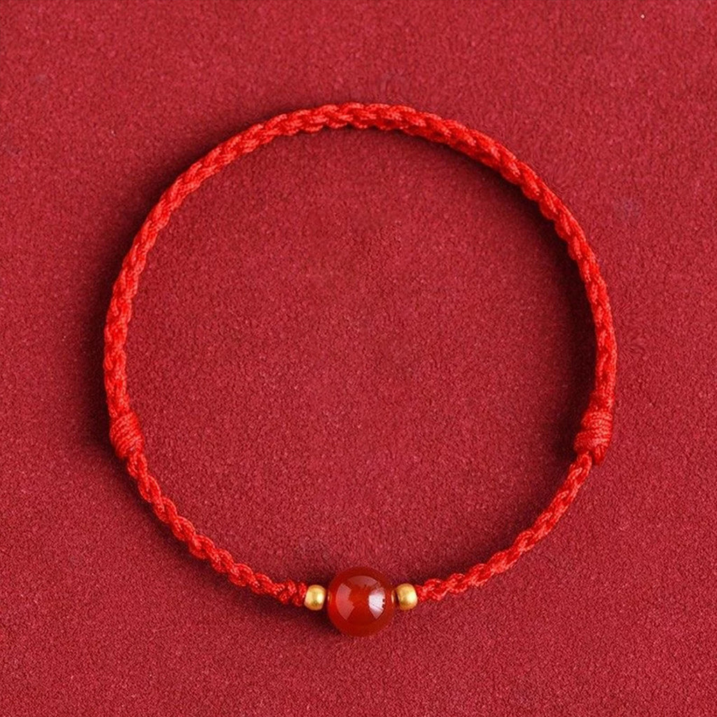 Red string bracelet with love beans