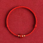 Red string bracelet with love beans