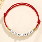 Red string with seven grains of rice