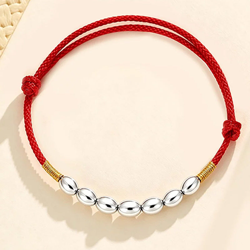 Red string with seven grains of rice