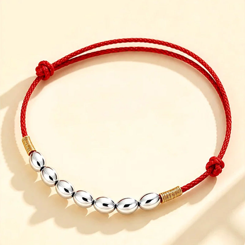 Red string with seven grains of rice