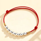 Red string with seven grains of rice