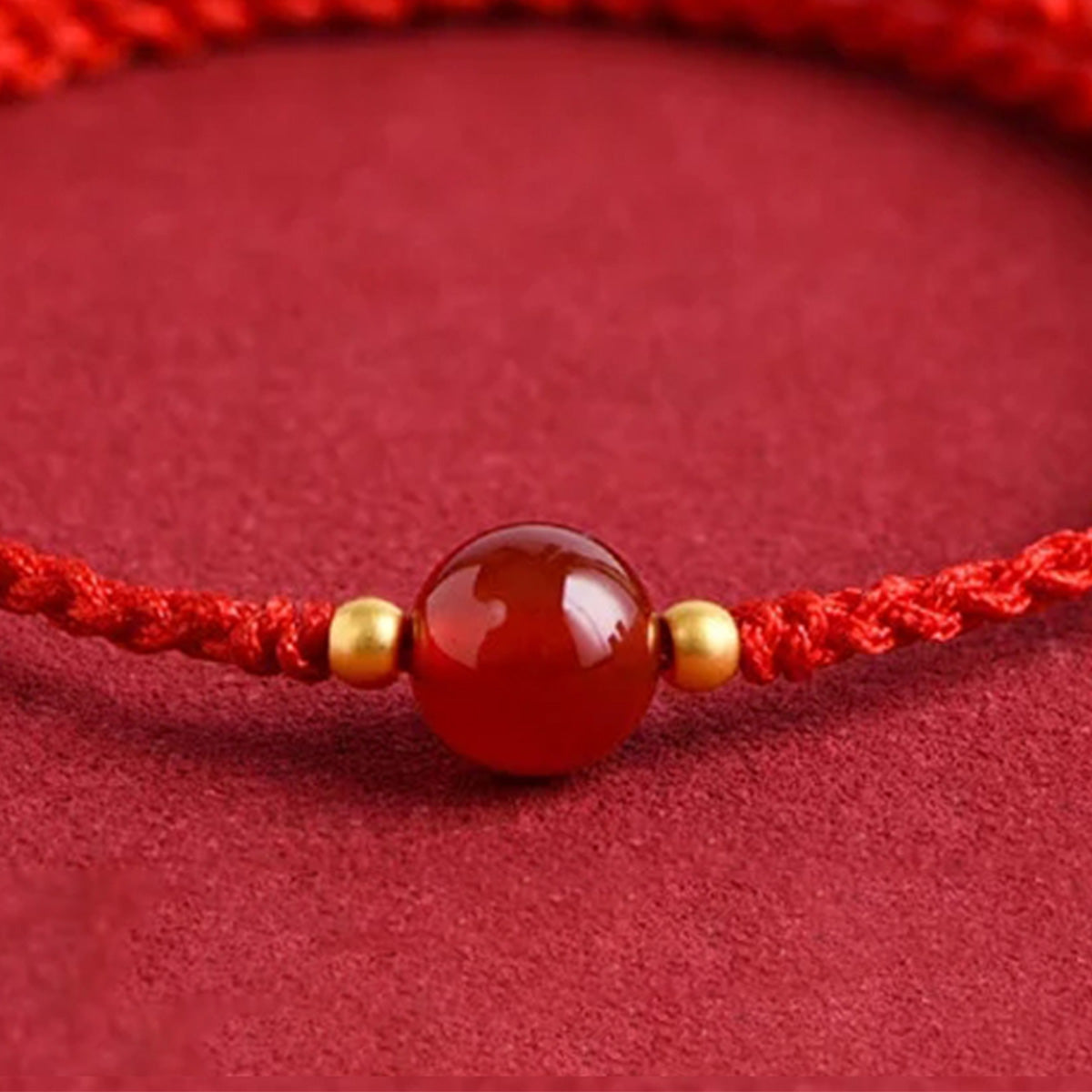Red string bracelet with love beans
