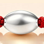 Red string with seven grains of rice