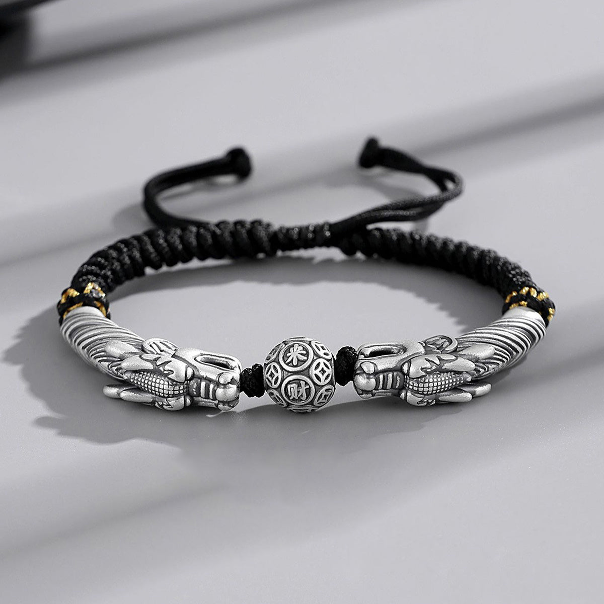 Black cord featuring two dragons playing with a pearl