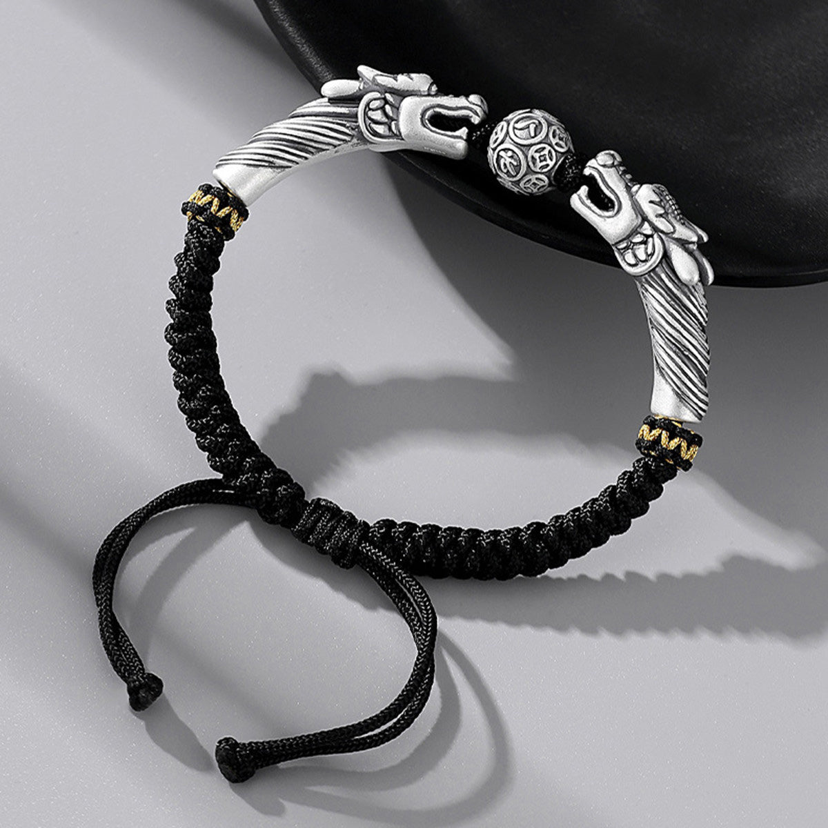 Black cord featuring two dragons playing with a pearl
